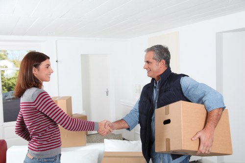Workers loading furniture carefully into a van