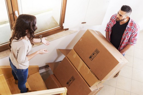 Careful unpacking of kitchen items in a Sutton property