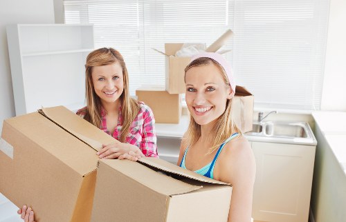Local movers navigating stairs and access challenges in a Sutton flat move