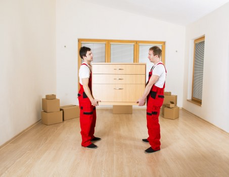 Moving crew organising boxes and furniture in Sutton