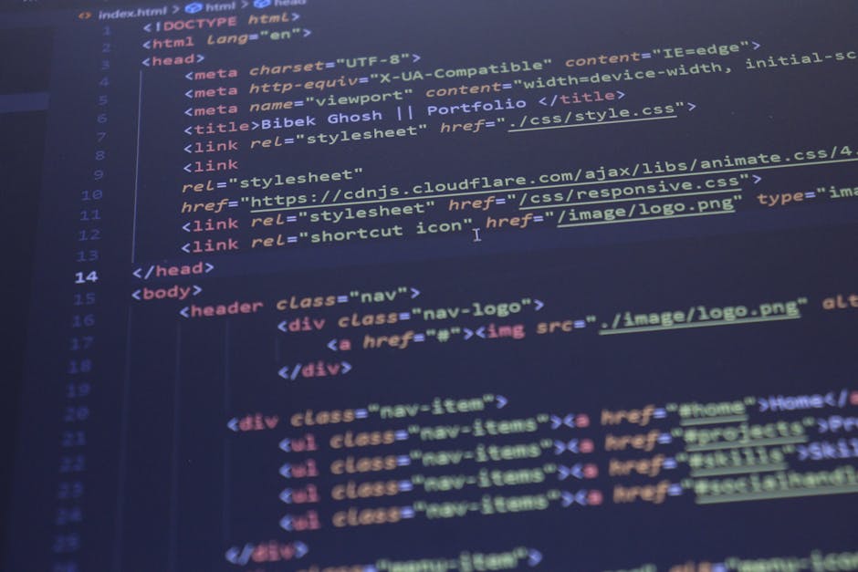 A person using a laptop computer with a black keyboard and a large screen displaying lines of code in a dark-themed text editor. The individual’s hands are positioned over the keyboard, with the rig
